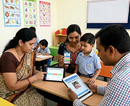 Preschool owner using digital end-to-end solution with teacher and students in classroom